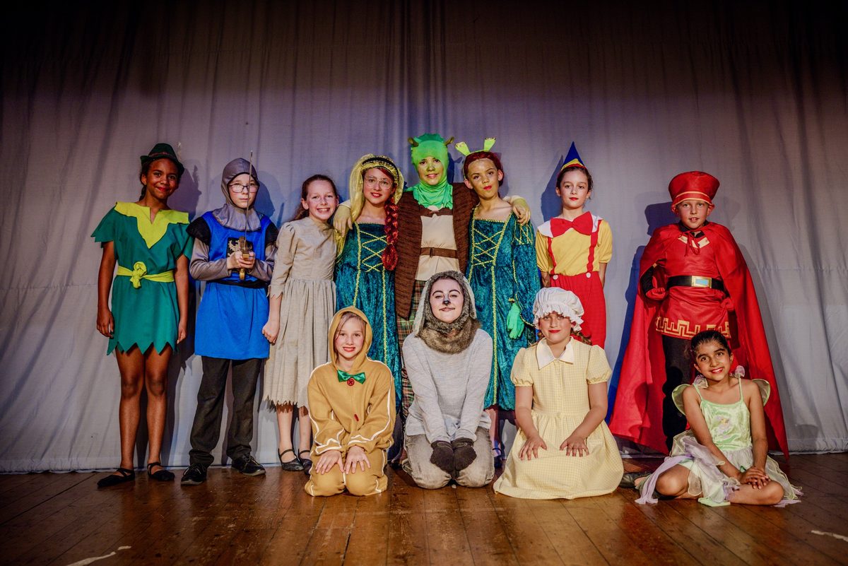 The StageShine cast on stage in costume for Shrek