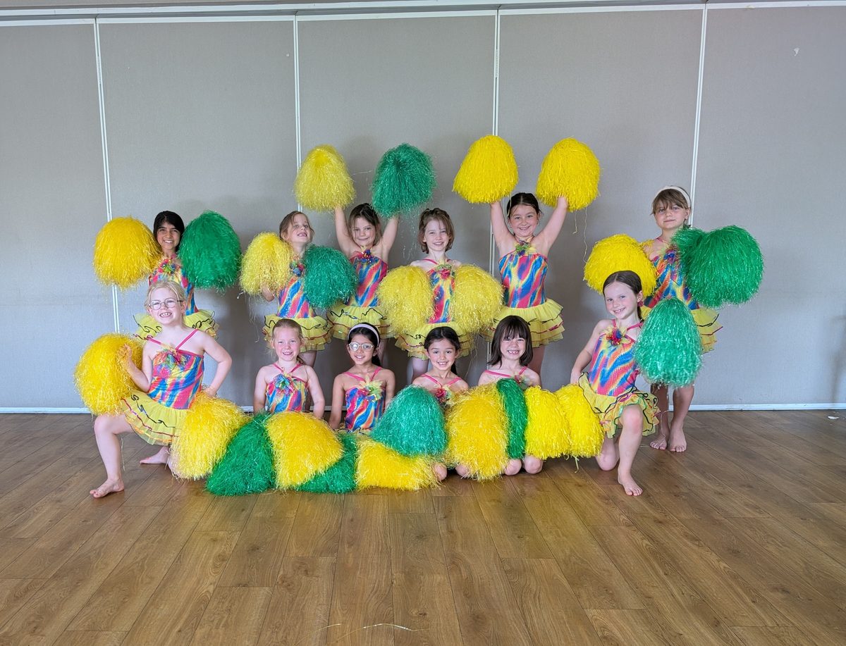Young dancers with yellow and green pom poms