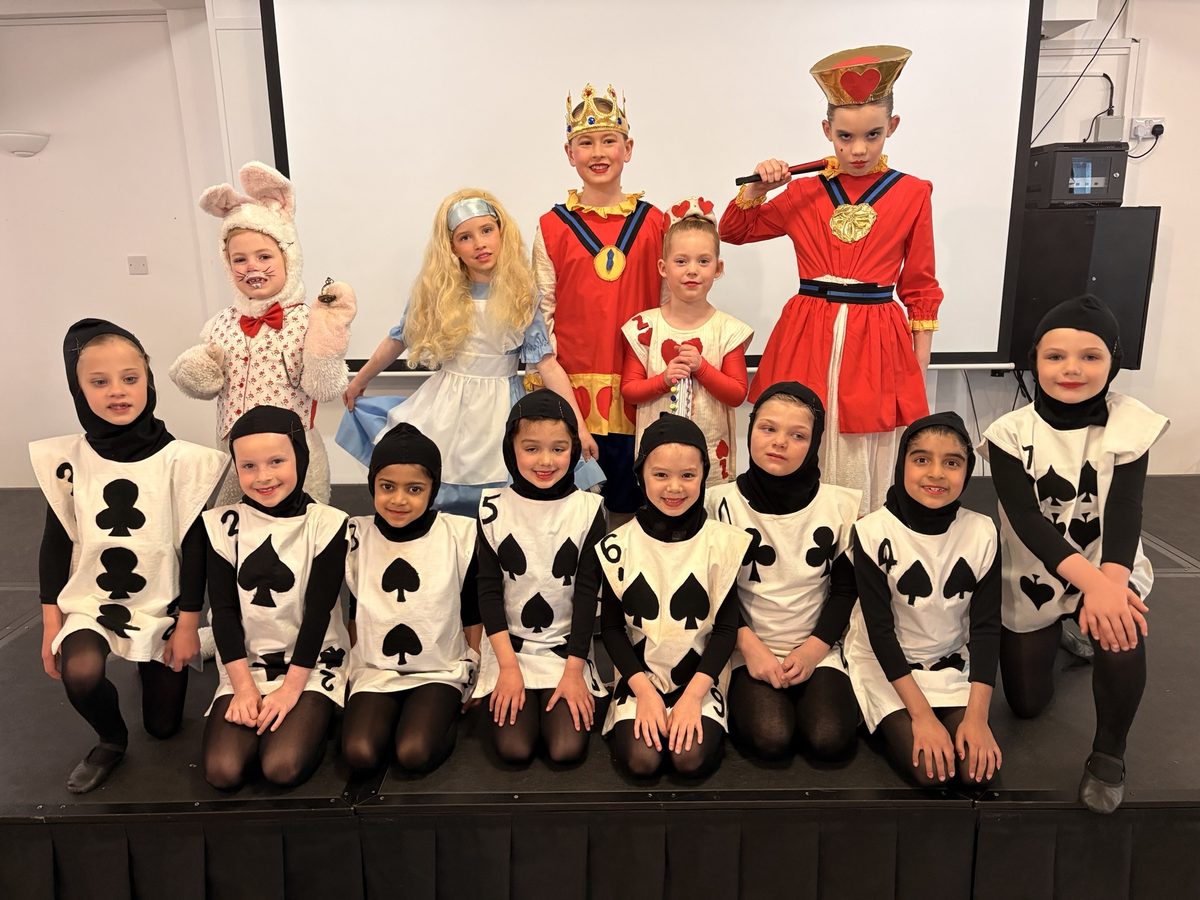 The Pre-Juniors competition group in Alice in Wonderland costumes